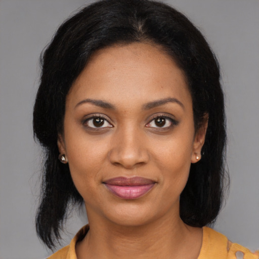 Joyful black young-adult female with medium  black hair and brown eyes
