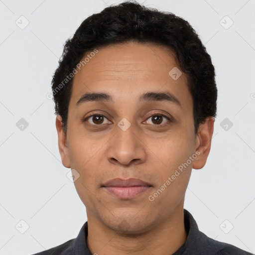 Joyful latino adult male with short  black hair and brown eyes