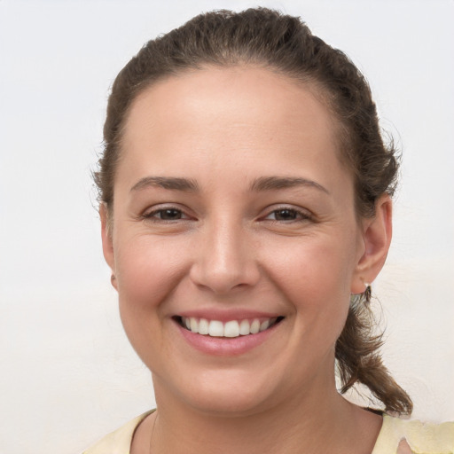 Joyful white young-adult female with short  brown hair and brown eyes