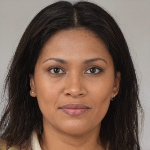 Joyful black young-adult female with long  brown hair and brown eyes
