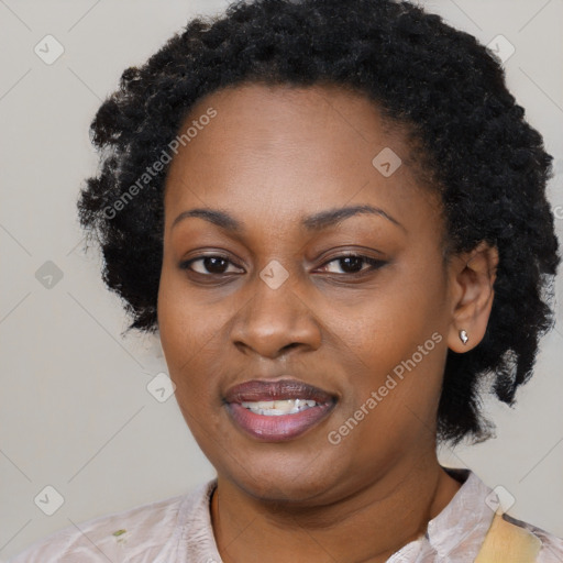 Joyful black adult female with short  black hair and brown eyes