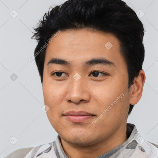 Joyful asian young-adult male with short  black hair and brown eyes