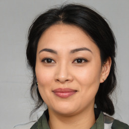 Joyful asian young-adult female with medium  brown hair and brown eyes