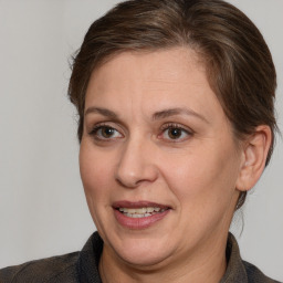 Joyful white adult female with medium  brown hair and brown eyes