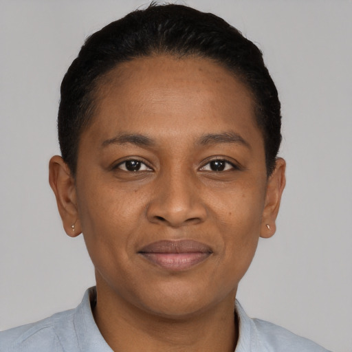 Joyful black young-adult female with short  black hair and brown eyes