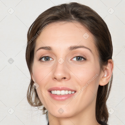 Joyful white young-adult female with medium  brown hair and grey eyes