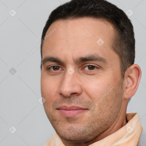 Joyful white adult male with short  brown hair and brown eyes