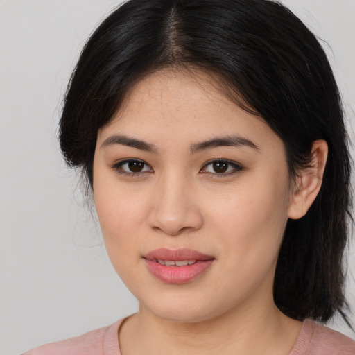 Joyful asian young-adult female with medium  brown hair and brown eyes