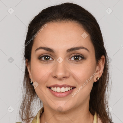 Joyful white young-adult female with long  brown hair and brown eyes