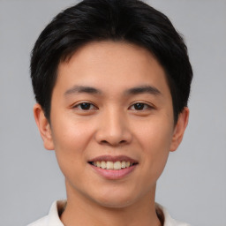 Joyful asian young-adult male with short  brown hair and brown eyes