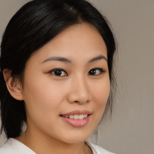 Joyful asian young-adult female with medium  black hair and brown eyes