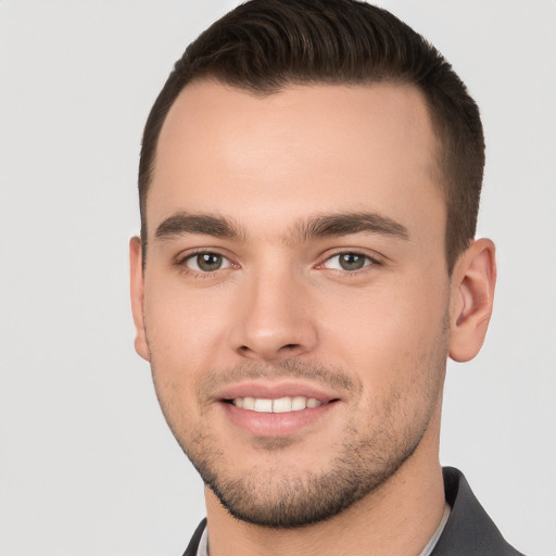 Joyful white young-adult male with short  brown hair and brown eyes