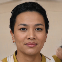 Joyful latino young-adult female with short  black hair and brown eyes