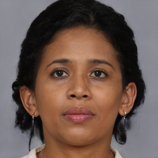 Joyful black young-adult female with medium  brown hair and brown eyes
