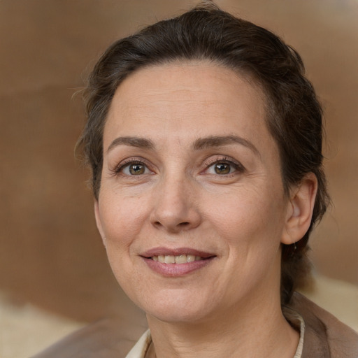 Joyful white adult female with medium  brown hair and brown eyes