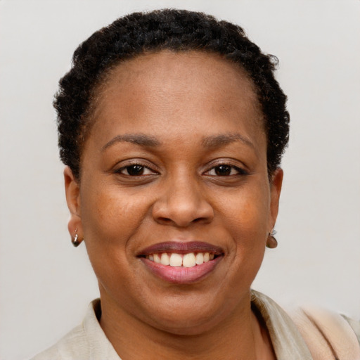 Joyful black adult female with short  brown hair and brown eyes