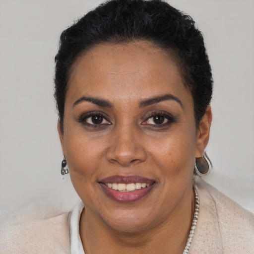 Joyful black young-adult female with short  brown hair and brown eyes