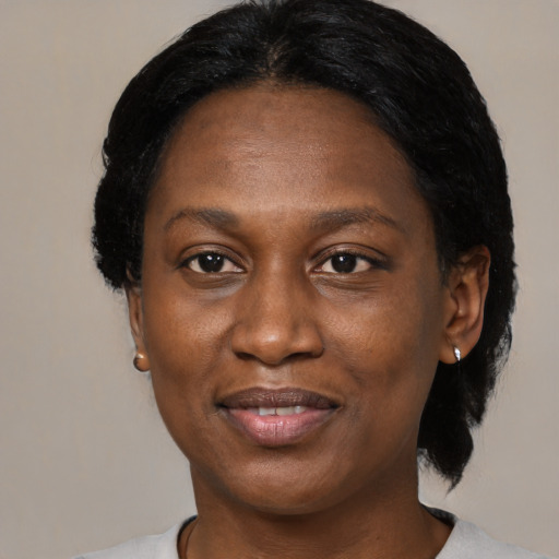 Joyful black adult female with medium  black hair and brown eyes