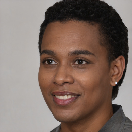 Joyful black young-adult male with short  black hair and brown eyes