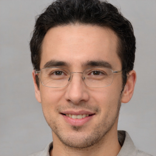 Joyful white adult male with short  brown hair and brown eyes