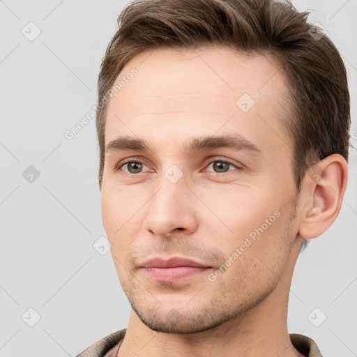 Joyful white young-adult male with short  brown hair and grey eyes