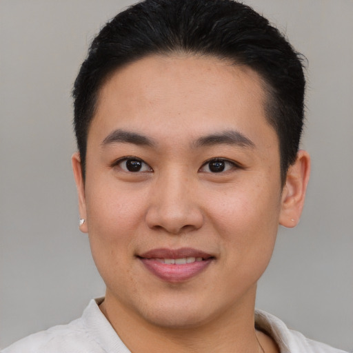 Joyful asian young-adult male with short  brown hair and brown eyes