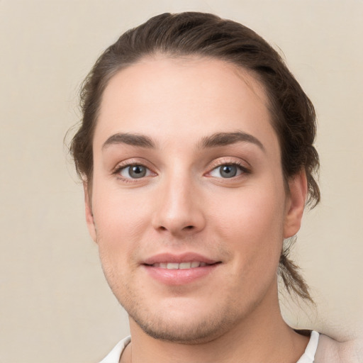 Joyful white young-adult female with short  brown hair and grey eyes