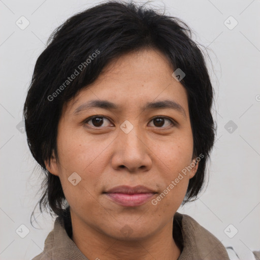 Joyful asian adult female with medium  brown hair and brown eyes