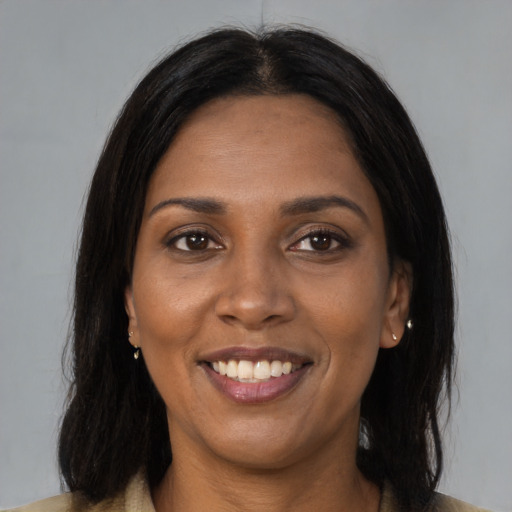 Joyful black young-adult female with medium  brown hair and brown eyes