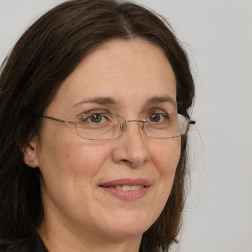 Joyful white adult female with long  brown hair and brown eyes