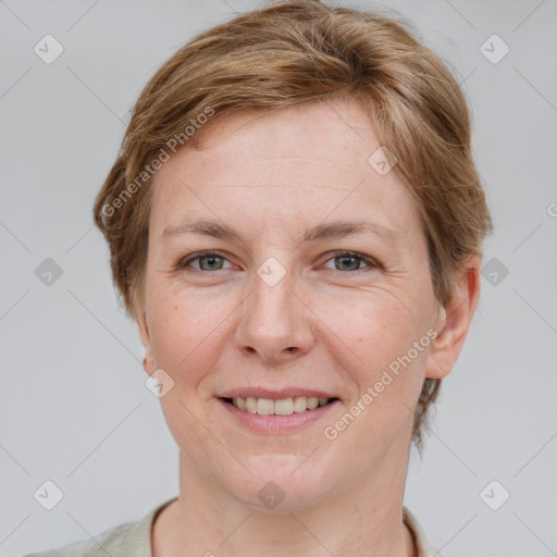 Joyful white adult female with short  brown hair and grey eyes