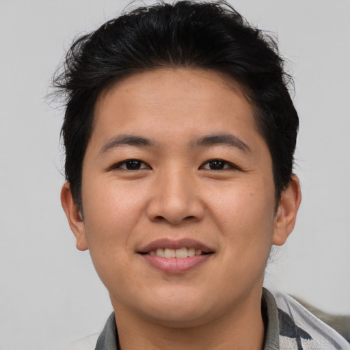 Joyful asian young-adult male with short  brown hair and brown eyes