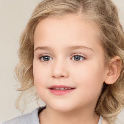 Joyful white child female with medium  brown hair and blue eyes