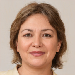 Joyful white adult female with medium  brown hair and brown eyes