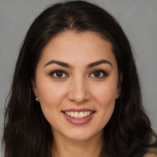 Joyful white young-adult female with long  brown hair and brown eyes