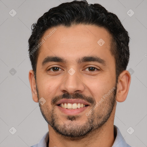 Joyful white young-adult male with short  black hair and brown eyes