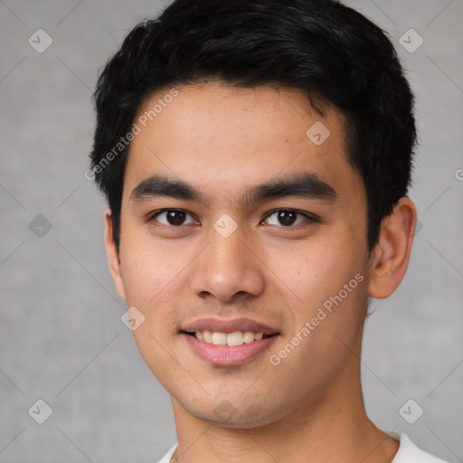 Joyful asian young-adult male with short  black hair and brown eyes