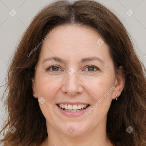 Joyful white adult female with long  brown hair and brown eyes