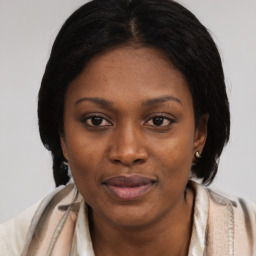 Joyful black young-adult female with medium  brown hair and brown eyes