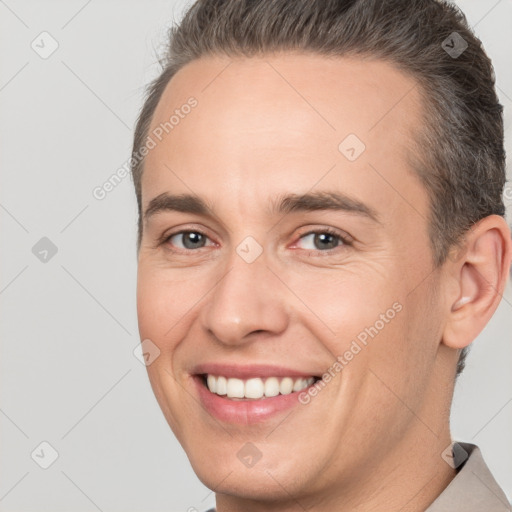 Joyful white adult male with short  brown hair and brown eyes