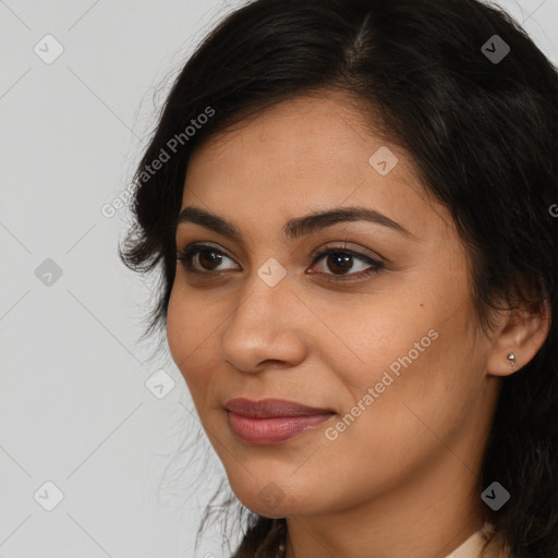 Joyful latino young-adult female with long  brown hair and brown eyes