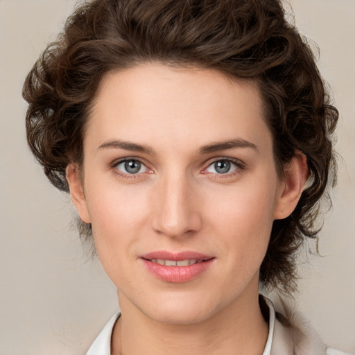 Joyful white young-adult female with medium  brown hair and green eyes