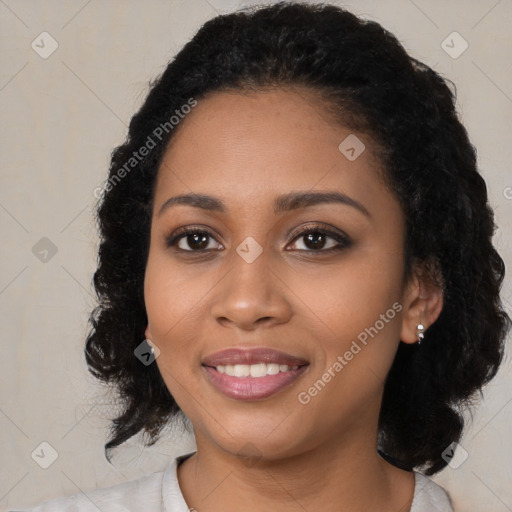 Joyful black young-adult female with medium  black hair and brown eyes