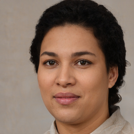 Joyful latino young-adult female with short  brown hair and brown eyes