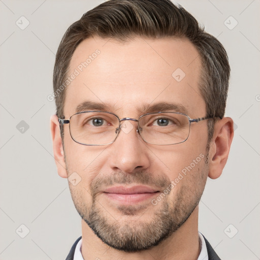 Joyful white adult male with short  brown hair and grey eyes