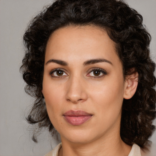 Joyful latino young-adult female with medium  brown hair and brown eyes