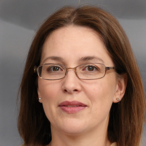 Joyful white adult female with medium  brown hair and blue eyes