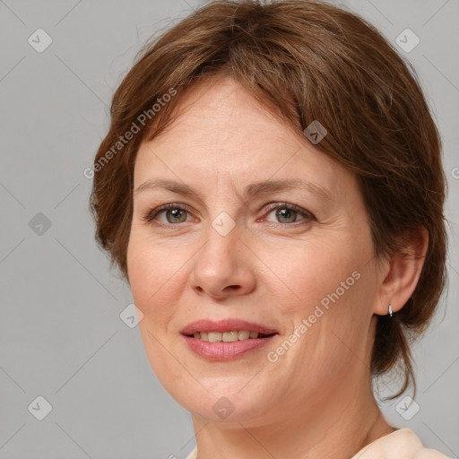 Joyful white adult female with medium  brown hair and grey eyes