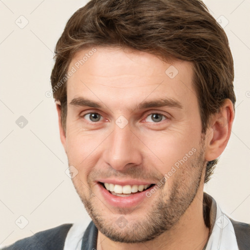 Joyful white young-adult male with short  brown hair and brown eyes