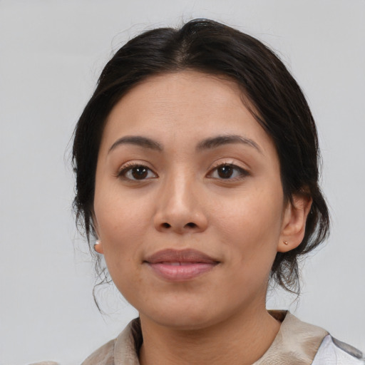 Joyful latino young-adult female with medium  brown hair and brown eyes